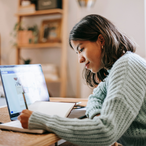 Woman sat at a laptop working